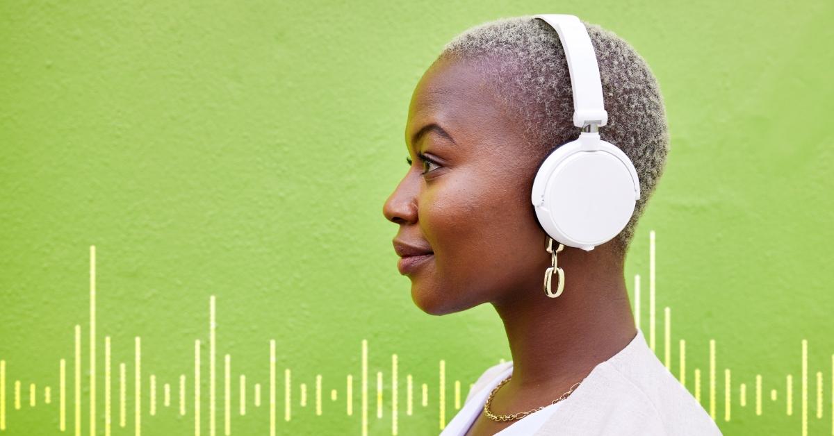 A Black woman with headphones staring forward