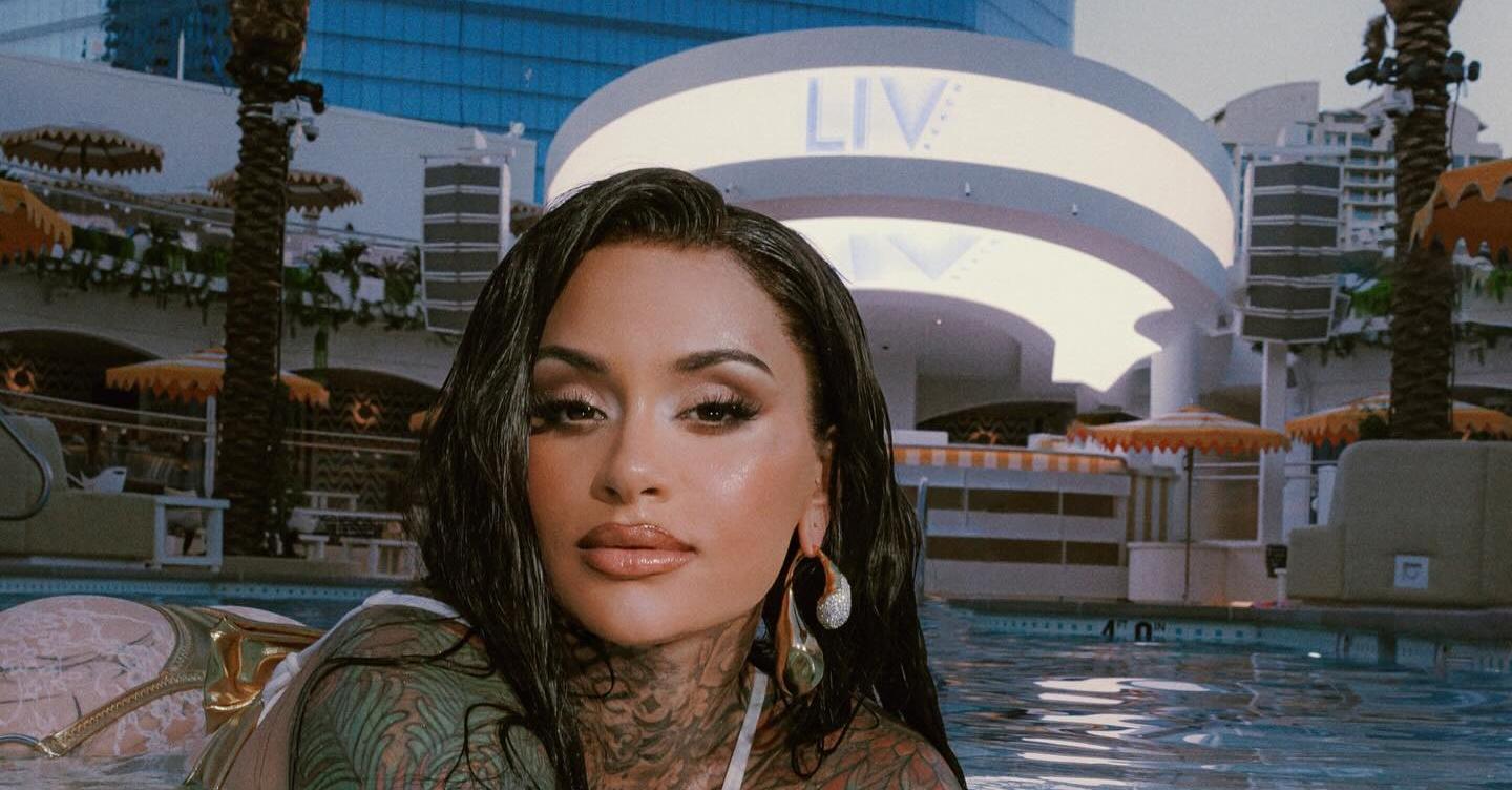 Kehlani poses in a pool in front of Club LIV