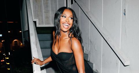 Coco Jones wears a black dress