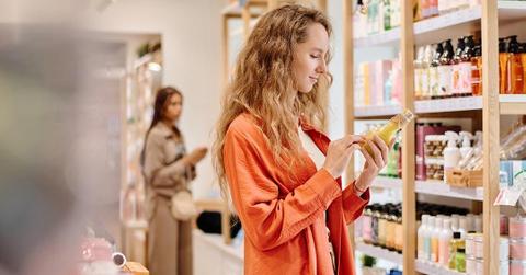 woman looks at beauty products