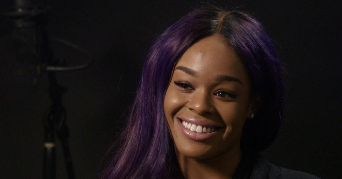 Azealia Banks' wears purple hair in an interview.
