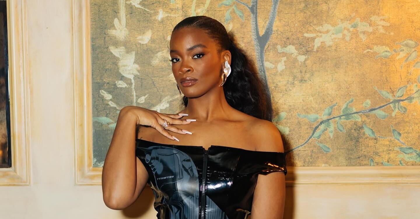 Ari Lennox wears a black dress.