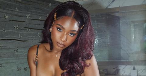 Normani with red hair at a Versace event.