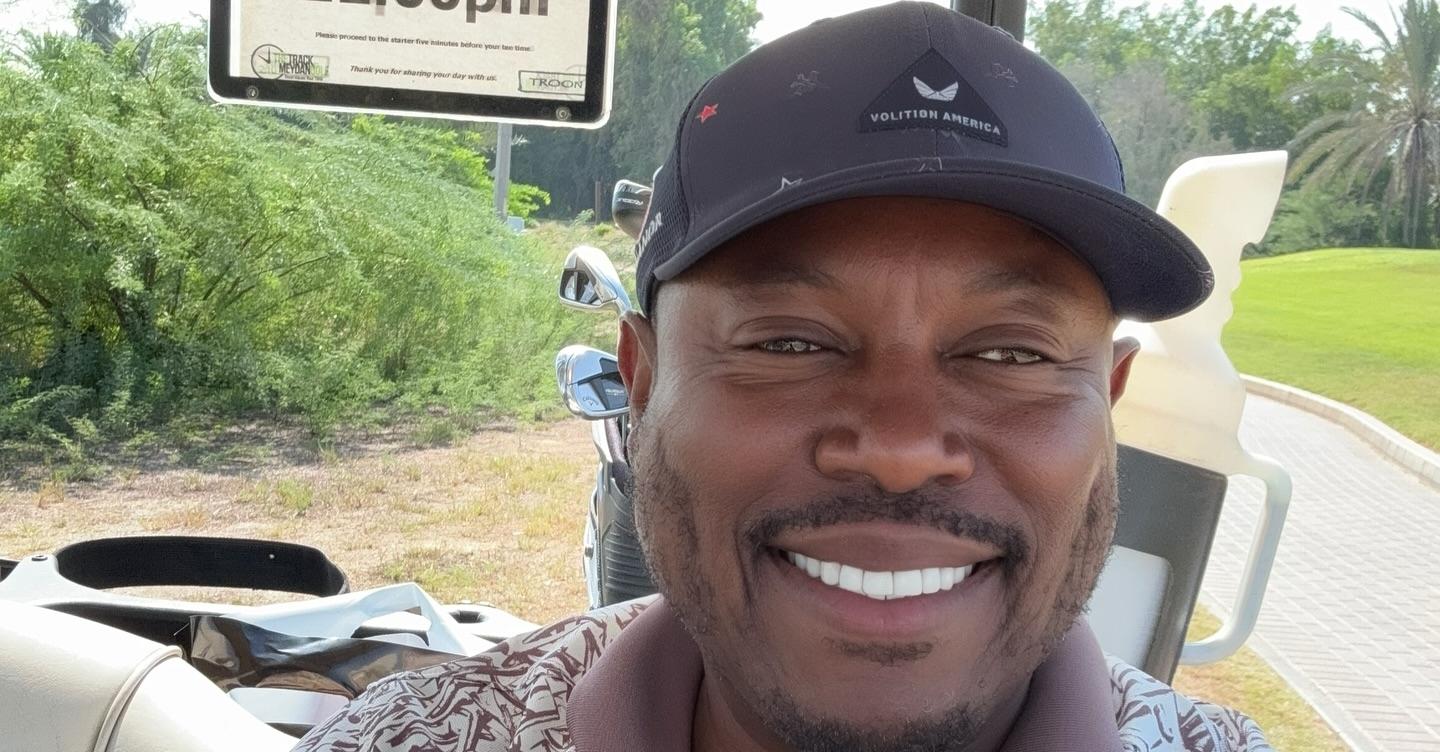 Simon Guobadia takes a selfie on a golf course.