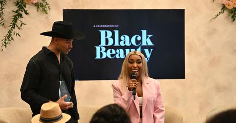 Sir John presents Jackie Aina with an award during the Black Beauty Roster Excellence Awards