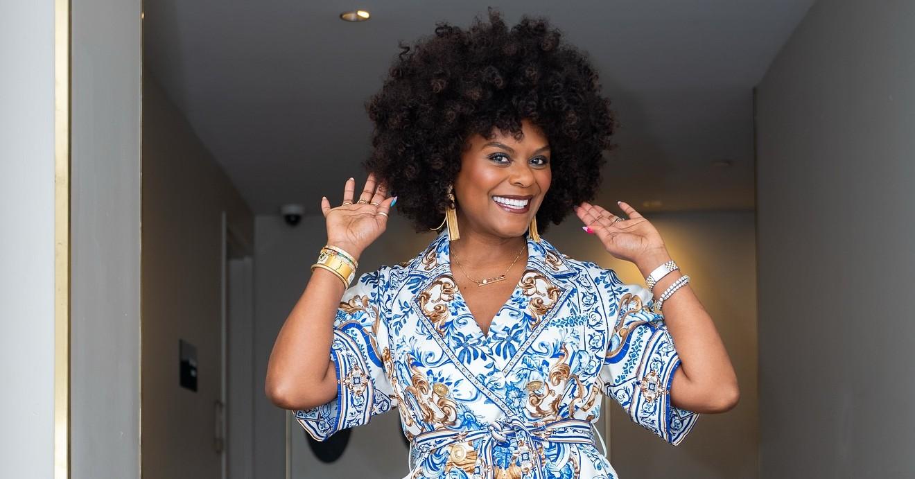 Tabitha Brown wears a gold and blue jumpsuit.