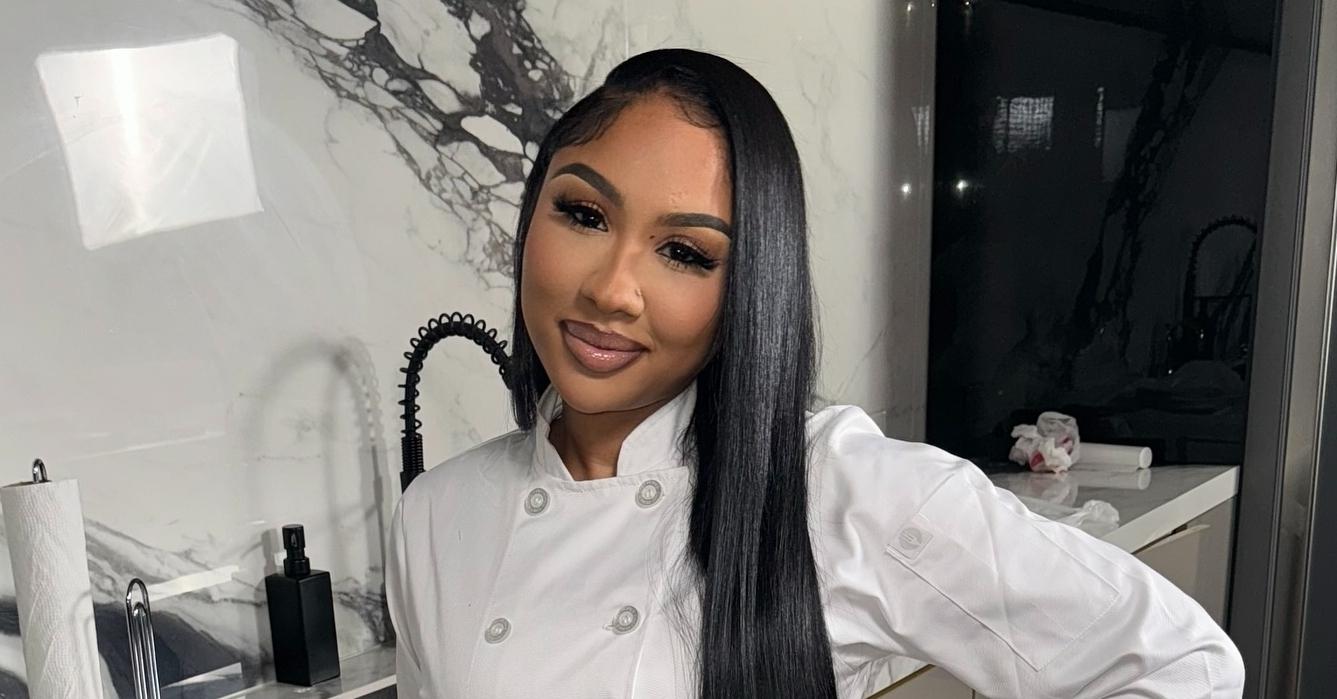 Ari Fletcher poses in the kitchen wearing a chef's apron.