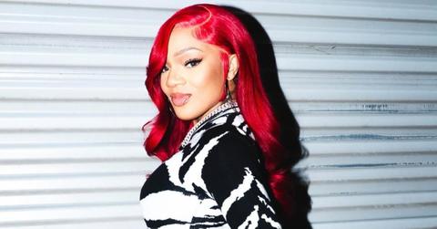 GloRilla is wearing a black and white bodysuit.